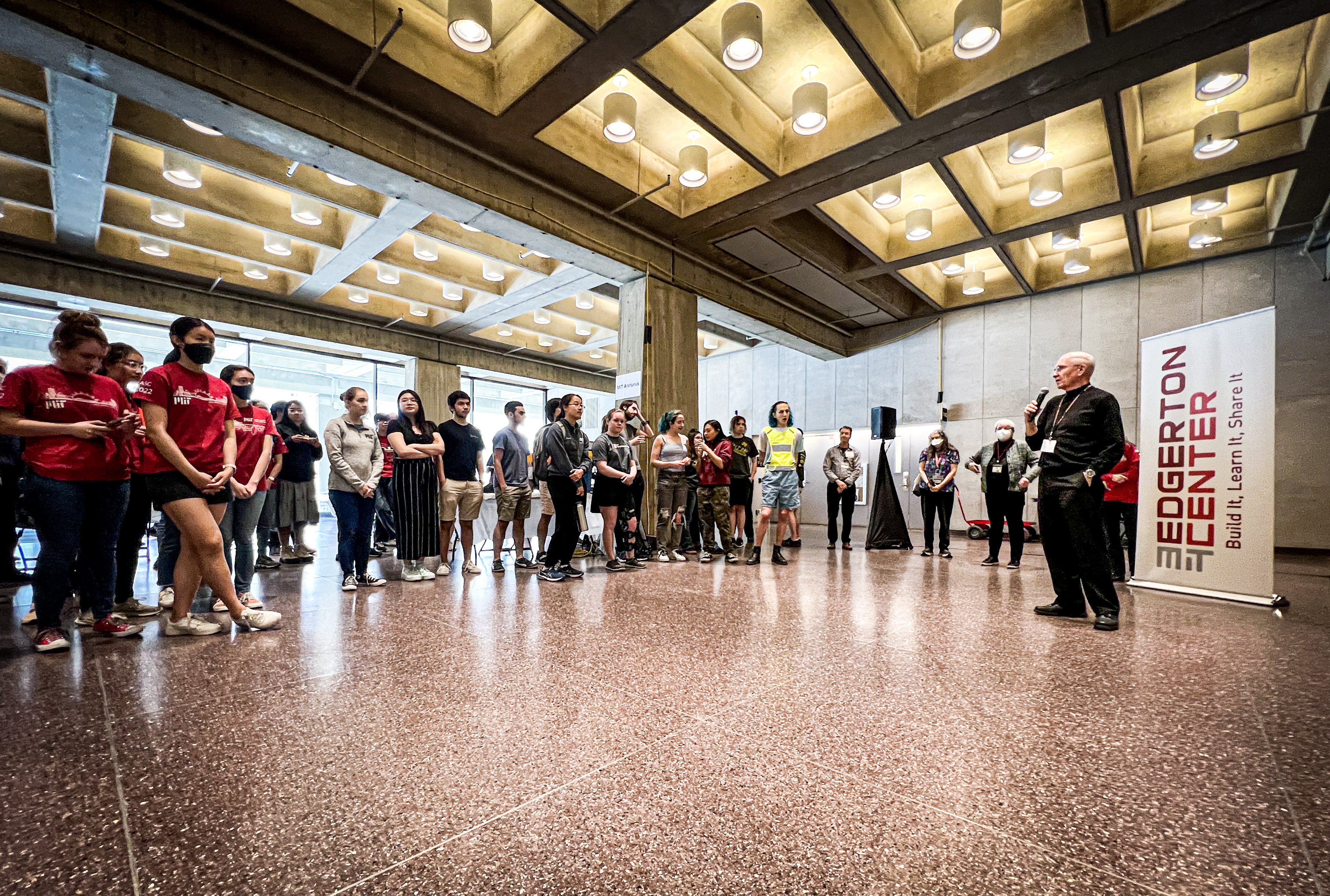 A horizontal image of the audience gathered around Professor Vandiver.