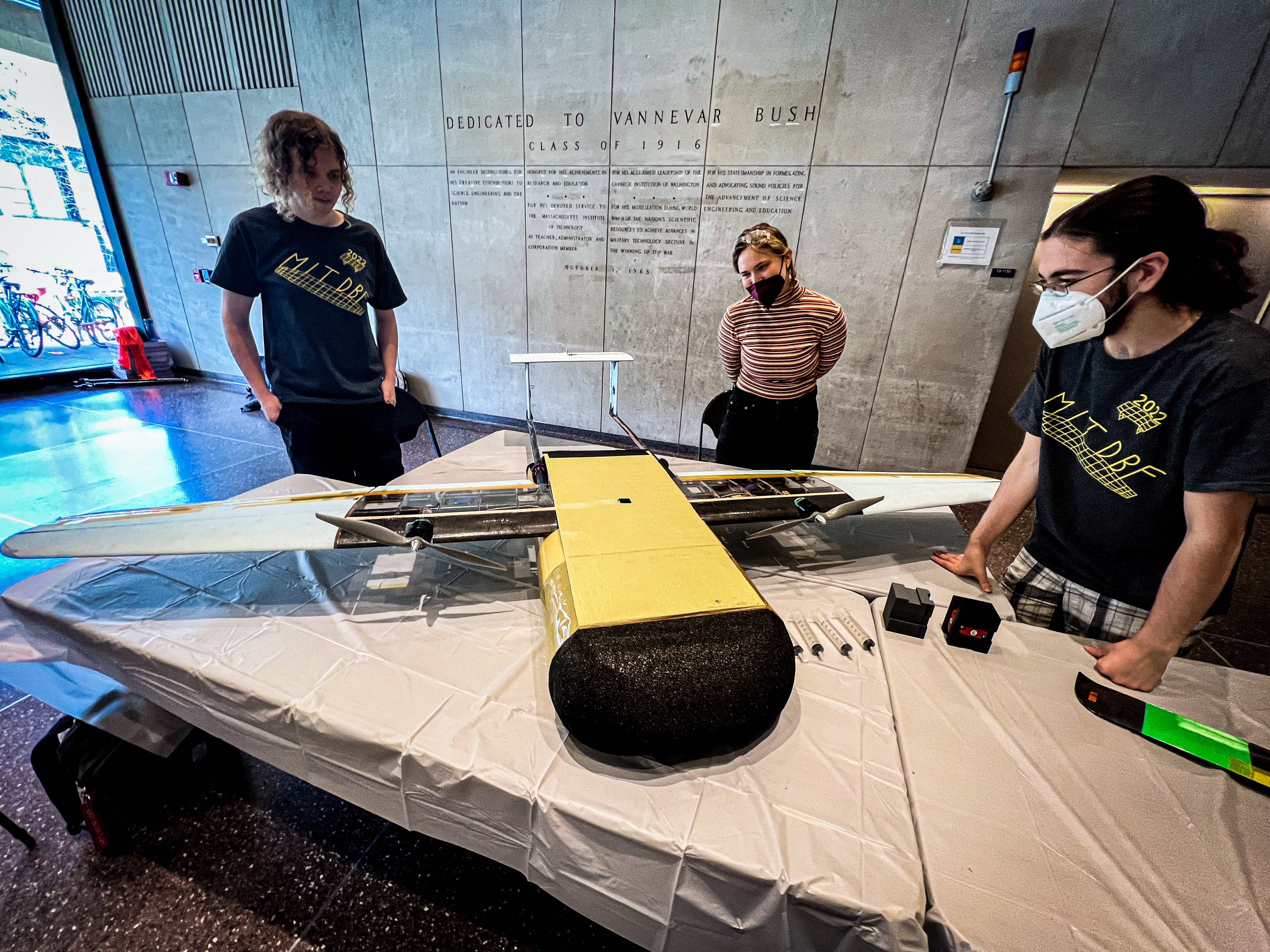 Members of the Design Build Fly showcasing their plane.