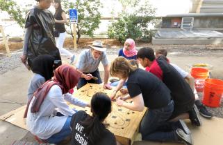 Ed Moriarty outside working on project with students