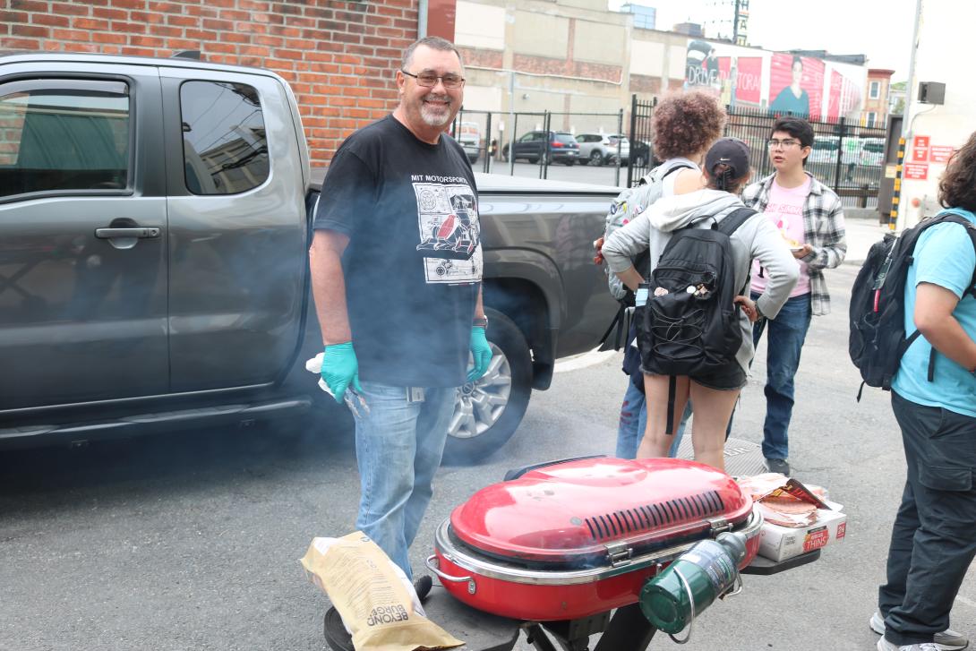 McAtamney cheerfully grilling hundreds of hot dogs and burgers for a long line of hungry students outside his N51 shop at the Open House for the Edgerton Center Clubs and teams.